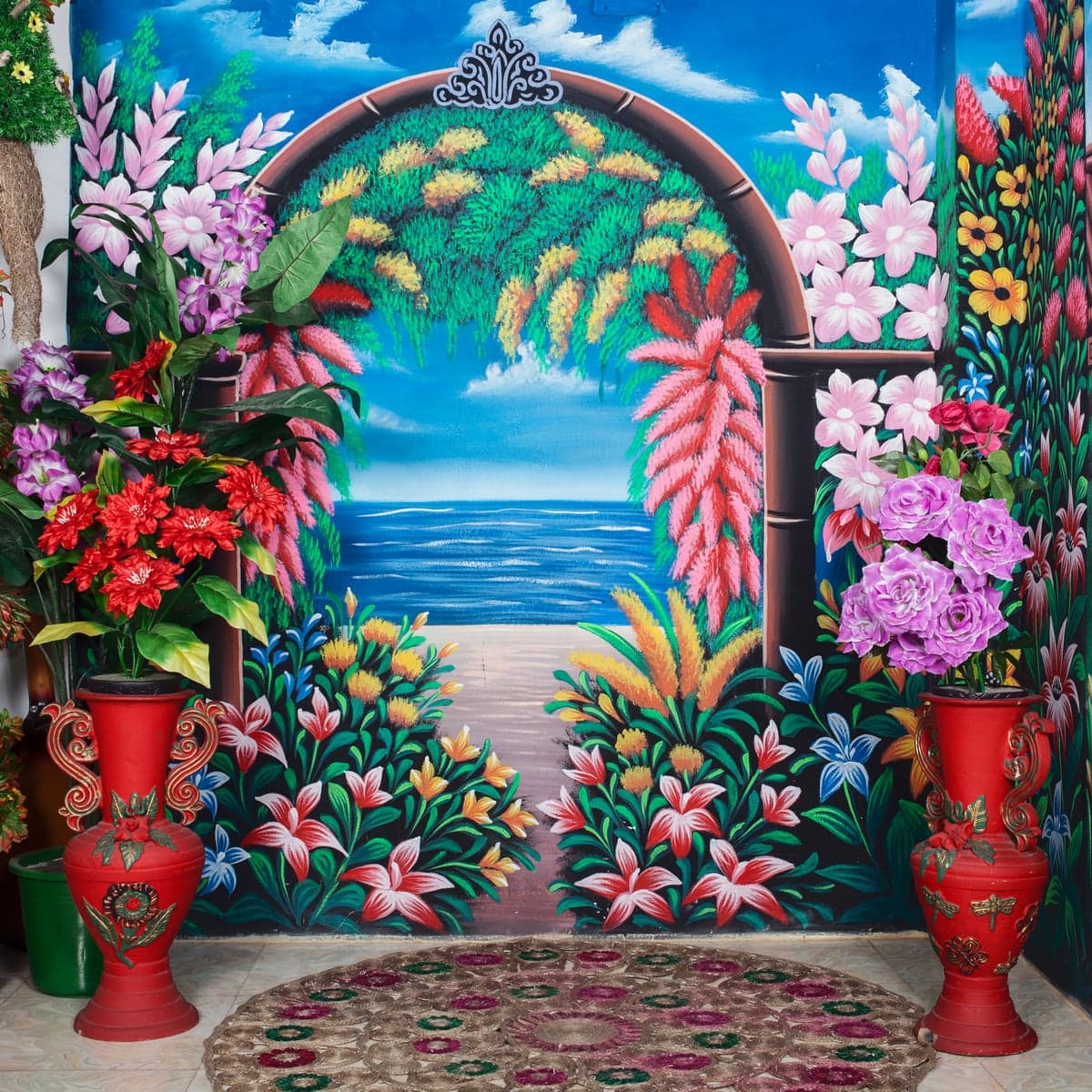 A vivid painted garden backdrop with flowers, birds and blue water